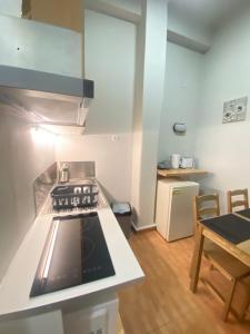 a small kitchen with a stove and a table at Athens City Themis13 in Athens