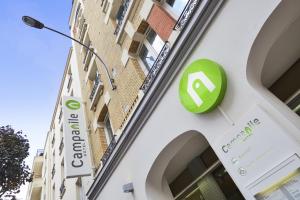 a building with a green sign on the side of it at Campanile Paris Ouest - Porte de Champerret Levallois in Levallois-Perret