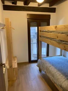 a bedroom with a bunk bed and a window at Monforte de la Sierra - Acogedora y cálida vivienda in Monforte de la Sierra