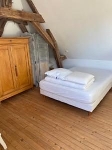 a bedroom with a bed and a wooden floor at Maîson Vigneronne in Nazelles