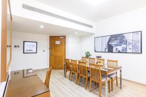 a dining room with a table and chairs at Golden Sands Suites in Dubai