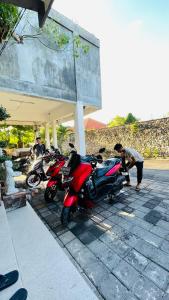 a group of motorcycles parked in front of a building at Satria Bungalow in Uluwatu