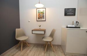 two chairs sitting next to a counter in a kitchen at History Hotel Tbilisi in Tbilisi City