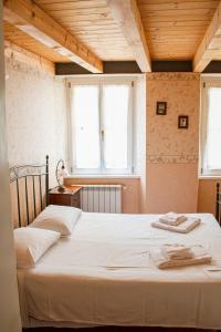 Postel nebo postele na pokoji v ubytování Hotel Capitelli