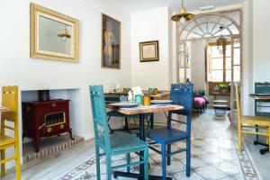 a dining room with blue chairs and a table at Villa Moana in Iznájar