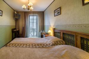 a bedroom with two beds and a window at Skipper Hotel in Kaliningrad