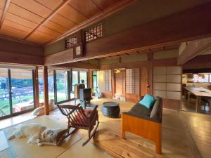 a living room with a dog laying on the floor at 犬と泊まれる平屋Dog friendly house 黄昏 in Misaki