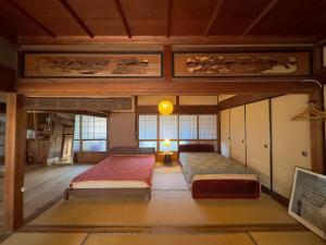 a large room with two beds in a room at 犬と泊まれる平屋Dog friendly house 黄昏 in Misaki