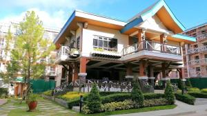 a building with a balcony on top of it at KILA Homes at Pine Suites Tagaytay in Tagaytay
