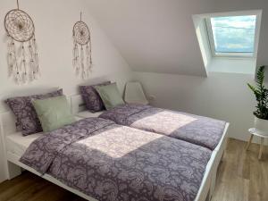 a bedroom with a bed with purple sheets and a window at Sunny Oak Estate in Mengeš