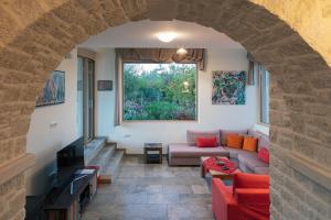 a living room with a couch and a window at Villa Luni in episkopi-chania