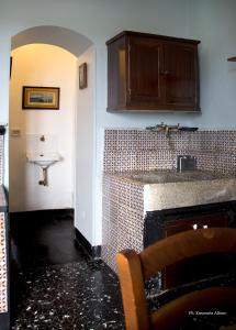 a kitchen with a counter and a sink in a room at Villa Castiglione 1863 - The real Sicilian holiday in Ragusa
