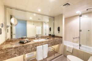 a bathroom with a sink and a mirror at Golden Sands Suites in Dubai