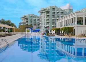 a swimming pool in front of a building at Royal Atlantis Spa & Resort in Side