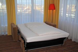 Postel nebo postele na pokoji v ubytování Akcent hotel