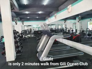a gym with a bunch of treadmills and machines at Gili Ocean Club - ADULTS ONLY in Gili Trawangan