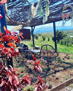 a group of chairs sitting under a roof at Cabañas Ladera de Nant y Fall -Tiny Houses- in Trevelin