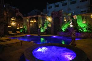a swimming pool at night with purple lights at Terra Firma Hotel Boutique in Villa Carlos Paz