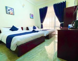 Postel nebo postele na pokoji v ubytování Bách Thảo Hotel