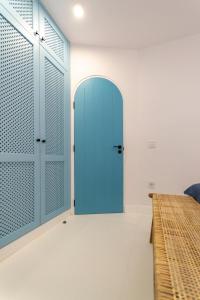 a blue door in a room with a bed at Apartamento nuevo y moderno in San Bartolomé