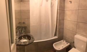 a bathroom with a shower with a sink and a toilet at Departamento - Edificio Costanera in San Salvador de Jujuy