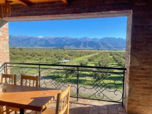 a view from the balcony of a house with a table and chairs at Mestvireni in Tʼelavi