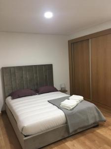 a bedroom with a large bed and a large closet at Casa do Castelo II in Bragança