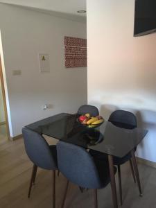 a table with two chairs and a bowl of fruit on it at Casa do Castelo II in Bragança