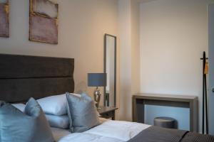 a bedroom with a bed with a mirror and a fireplace at Apartment 4 2 bedroom, sleeps x 6 in York