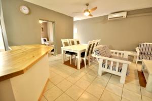 a kitchen and dining room with a table and chairs at The Bridge Apartments Unit 35 in St Lucia