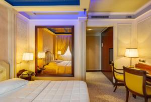 a hotel room with a bed and a desk and a bedroom at Dreamhotel in Appiano Gentile +56 photos