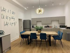 a kitchen and dining room with a table and chairs at Apartment 5 4 bedrooms, sleeps x 15 in York