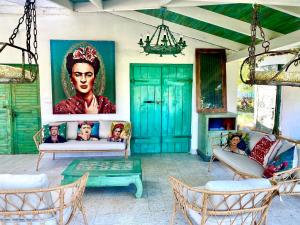 a living room with a painting of a woman at Bohemian Eco lodge át lake Balaton in Kisapáti