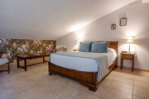 a bedroom with a large bed with blue pillows at María de Molina in Úbeda