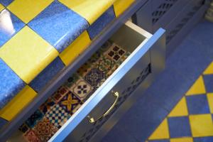 a kitchen with blue and yellow tiles on the floor at B&B Milleduecento Luxury Room in Salerno