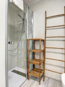 a shower with a wooden shelf in a bathroom at Elisa Beach Apartment - 8209 in Santiago de la Ribera