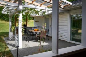 a pergola on a patio with a table and chairs at Fabulous Home W Outdoor Kitchen, Fire Pit And Back Yard! in Morristown