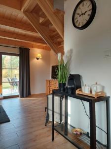 a living room with a clock on the wall at Domek nad Marychą - Zelwa in Zelwa