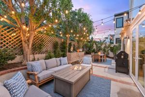 a patio with a couch and a fire pit at Dana Point Deluxe in Dana Point