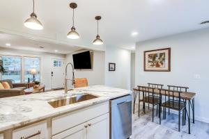 a kitchen with a sink and a living room at Pleasant Dreams in Charleston