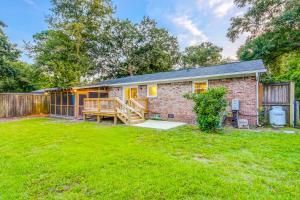 a brick house with a fence and a yard at Pleasant Dreams in Charleston