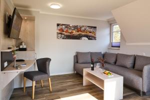 a living room with a couch and a table at R&R Strandhotel Baabe in Baabe