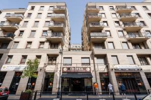 a tall white building with a hotel sign on it at King Care Apartment with A/C in Budapest