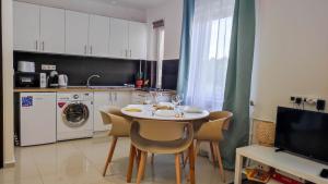a kitchen with a table and chairs in a kitchen at Warm Family Snug in Budapest
