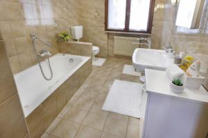 a bathroom with a tub and a toilet and a sink at La casa di Mario e Olga in San Martino +12 photos