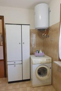 a laundry room with a washing machine and a washer at La casa di Mario e Olga in San Martino