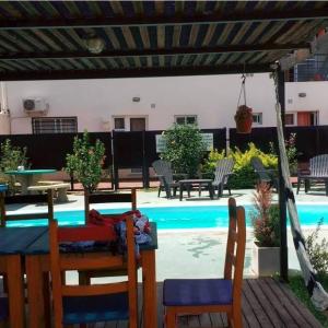 a patio with a table and chairs next to a pool at Atalaya in Colón