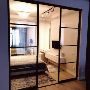 a room with a mirror and a bedroom with a bed at Lovely 1-bedroom rental unit in downtown in Dushanbe +11 photos
