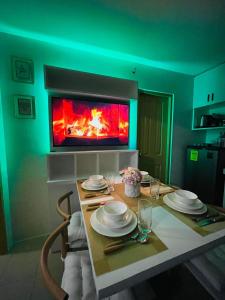 a dining room with a table and a fireplace at Lovely 2 bedroom condo unit in Iloilo City