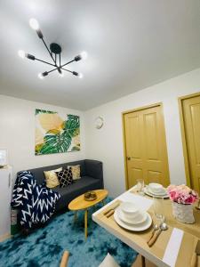 a living room with a couch and a table at Lovely 2 bedroom condo unit in Iloilo City +14 photos